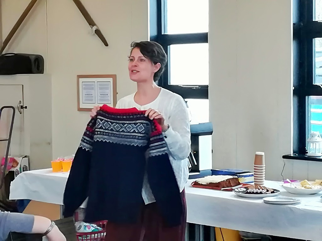 Dr Torun Kjolberg speaking about Norwegian history and tradition of Knitting, showing a Marius patterend jumper