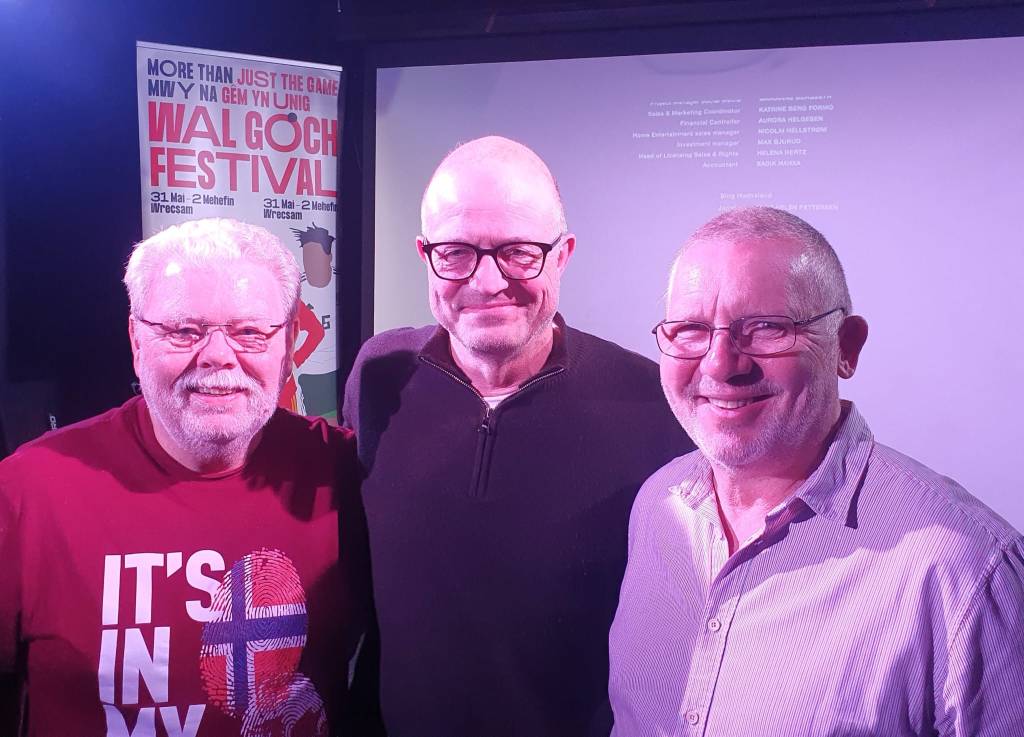 Mark Hinge (L) and Kevin Burden (R) of WNS welcome Karl-Petter Løken, the general secretary of the Norwegian Football Association, to Cardiff.